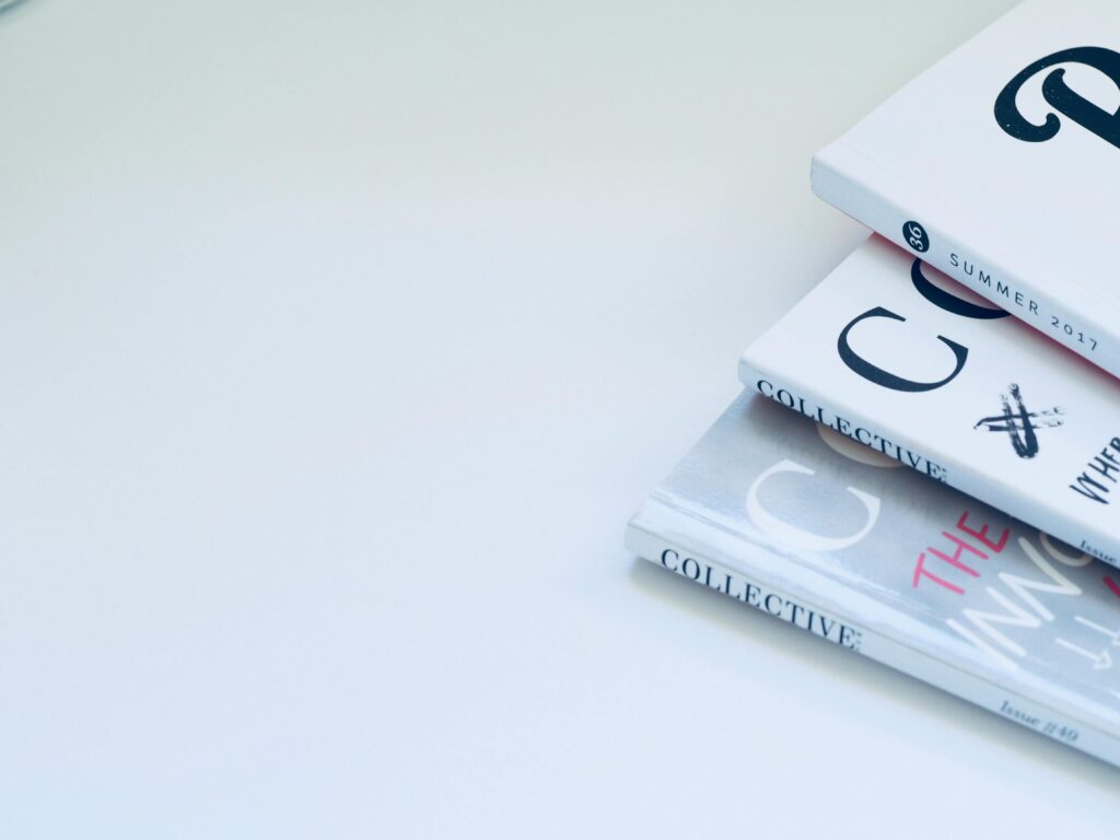 Stack of minimalist designed books on a clean white surface, perfect for creative concepts.
